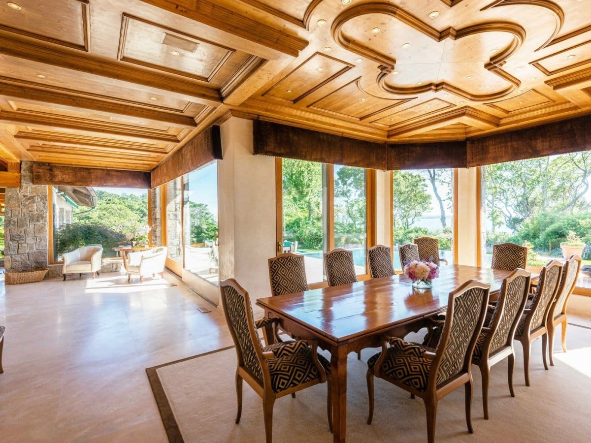There's also another room with an eight-seat dining room table under an elaborate wood-work ceiling.