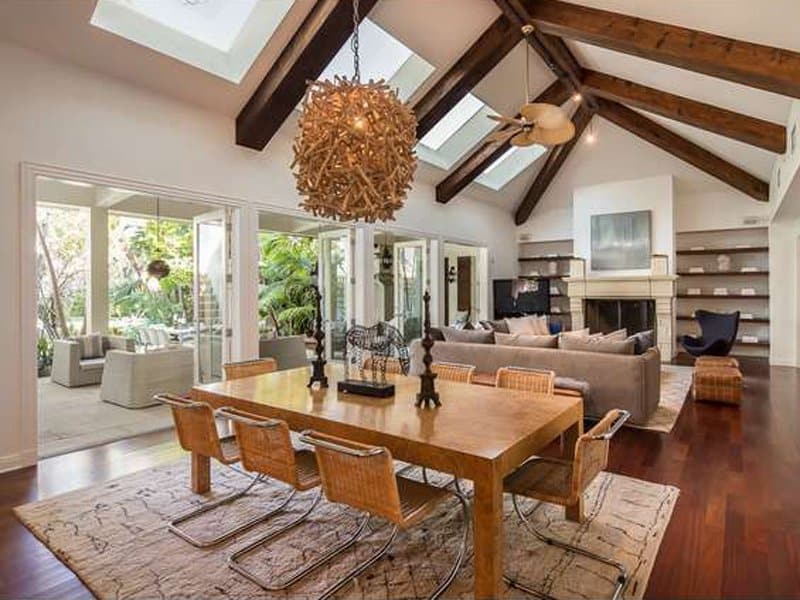 Which has a large vaulted ceiling and exposed wood beams. 