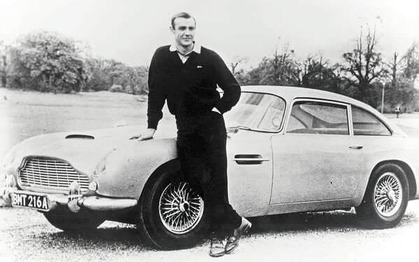 Sean%20Connery%20as%20James%20Bond%2C%20poses%20with%20Aston%20Martin%20DB5%20-%201965