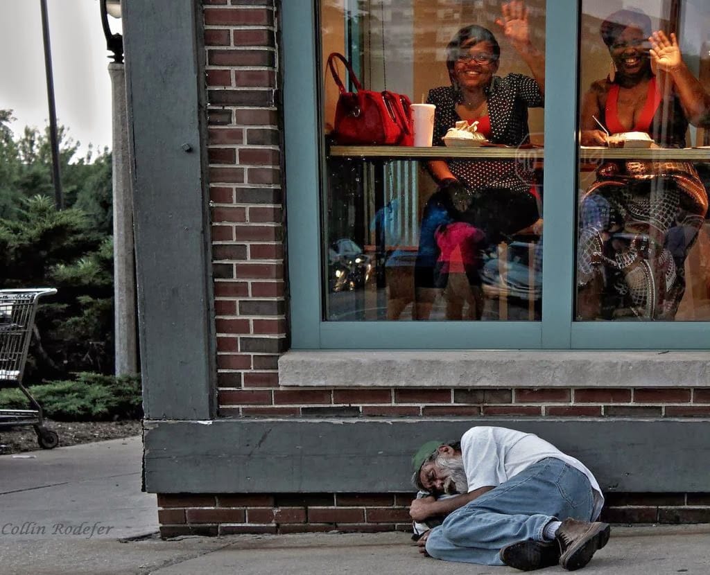 Ignorance is bliss – Homeless man sleeps outside a diner in Milwaukee