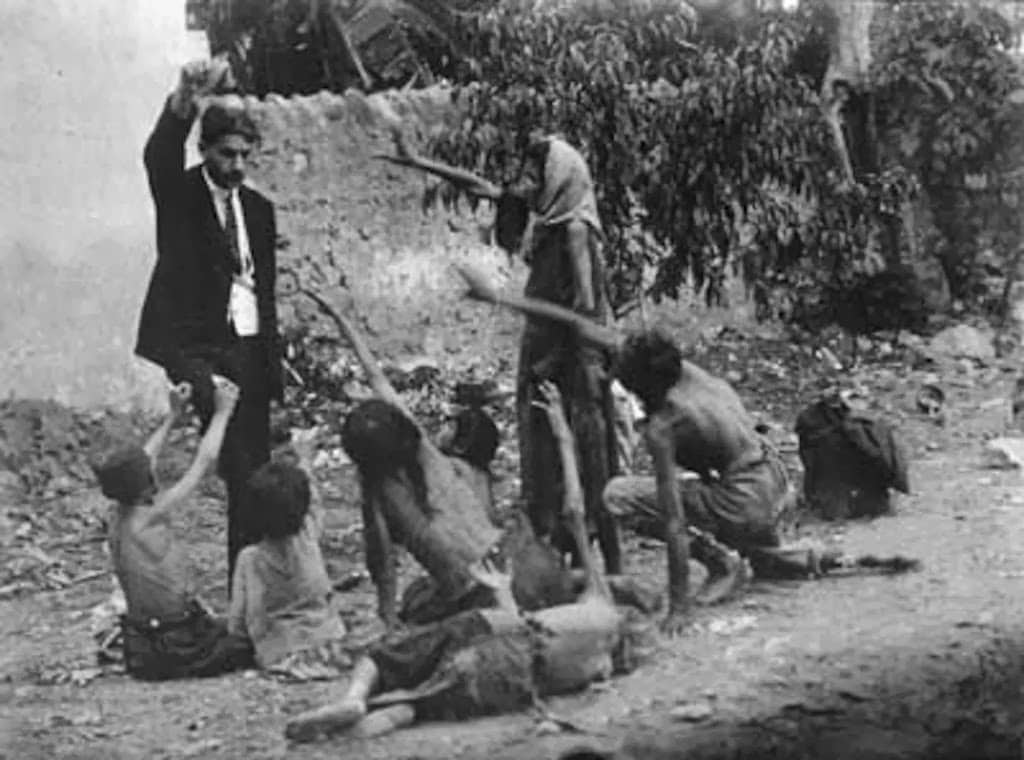 turkish official teases starving armenian children by showing them a piece of bread during the armenian genocide in 1915