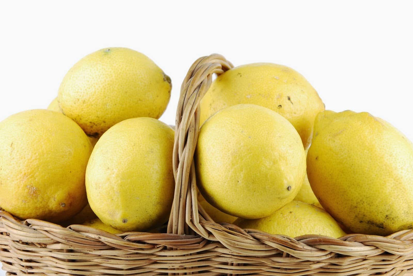 1786916 close up of lemons in a wicker basket on white 040214 900