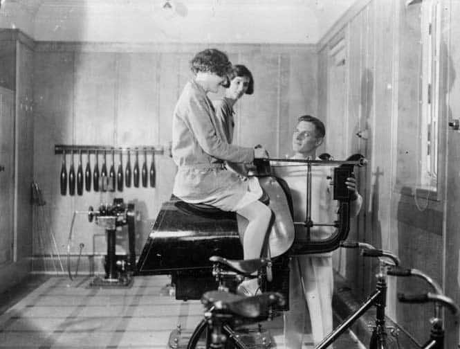 Passengers on the Canadian Pacific liner Duchess of Bedford keep fit in the ship's gymnasium, with the help of a riding machine.   (Photo by Douglas Miller/Getty Images)