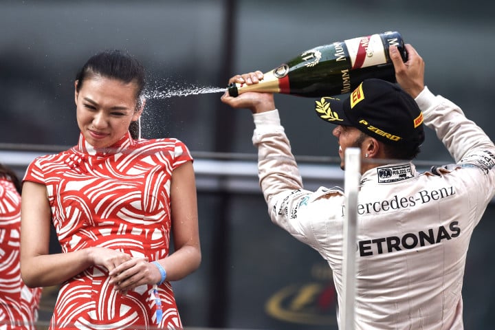 TOPSHOTS Mercedes AMG Petronas F1 Team's British driver Lewis Hamilton celebrates after winning the Formula One Chinese Grand Prix in Shanghai on April 12, 2015.  AFP PHOTO / FRED DUFOURFRED DUFOUR/AFP/Getty Images