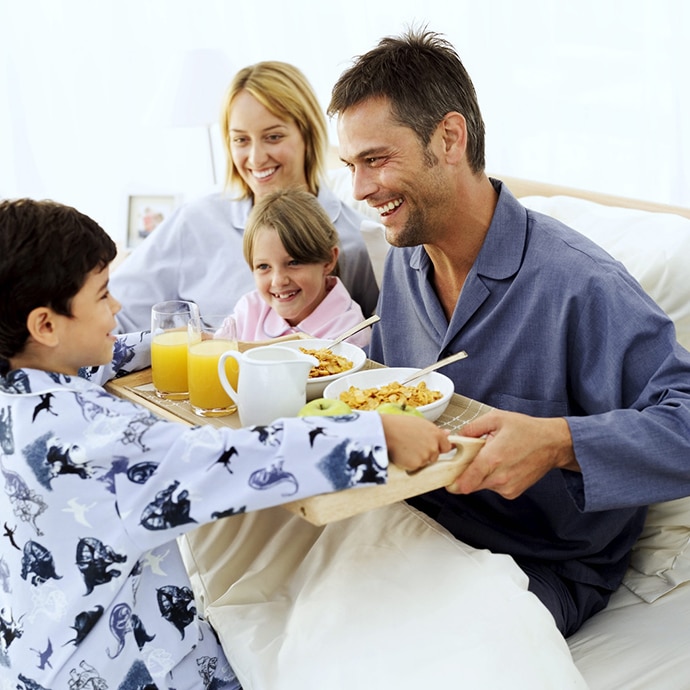 Boy Giving His Parents and Sister (5-9) Breakfast in Bed
