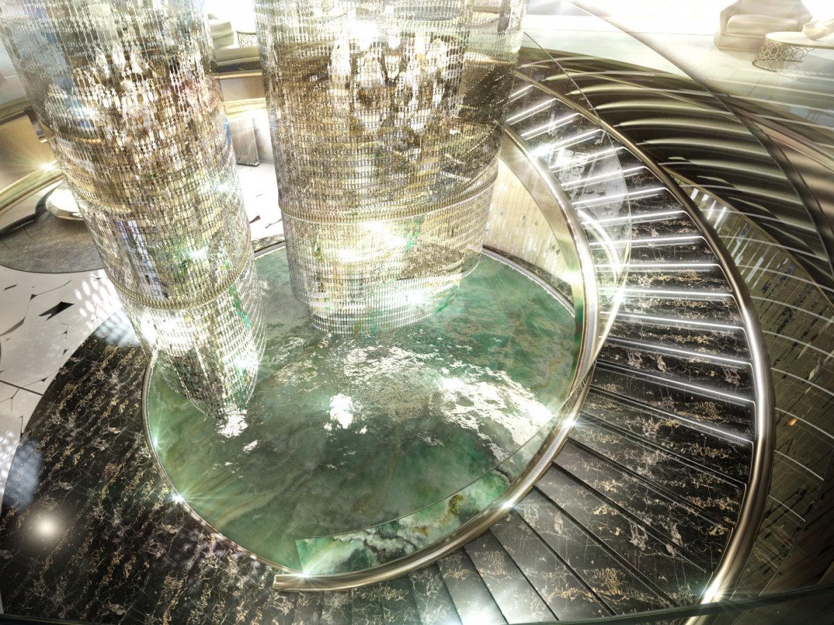 the-centerpiece-of-the-salon-is-a-huge-chandelier-surrounded-by-a-circular-staircase