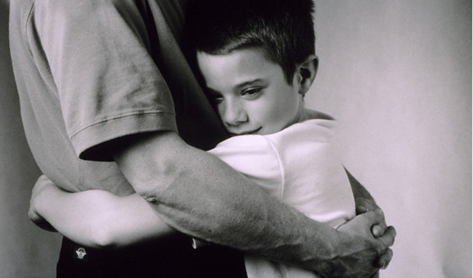 Son hugging father --- Image by © Robert Essel NYC/CORBIS