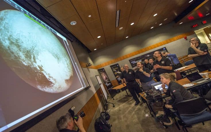 Members of the New Horizons science team react to seeing the spacecraft's last and sharpest image of Pluto before closest approach later in the day at the Johns Hopkins University Applied Physics Laboratory (APL) in Laurel, Maryland July 14, 2015.More than nine years after its launch, a U.S. spacecraft sailed past Pluto on Tuesday, capping a 3 billion mile (4.88 billion km) journey to the solar system's farthest reaches, NASA said. The craft flew by the distant "dwarf" planet at 7:49 a.m. after reaching a region beyond Neptune called the Kuiper Belt that was discovered in 1992. The achievement is the culmination of a 50-year effort to explore the solar system.    REUTERS/Bill Ingalls/NASA/Handout  ATTENTION EDITORS - FOR EDITORIAL USE ONLY. NOT FOR SALE FOR MARKETING OR ADVERTISING CAMPAIGNS. THIS IMAGE HAS BEEN SUPPLIED BY A THIRD PARTY. IT IS DISTRIBUTED, EXACTLY AS RECEIVED BY REUTERS, AS A SERVICE TO CLIENTS. MANDATORY CREDIT