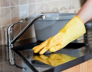 Close-up of a woman cleaning a kitchen