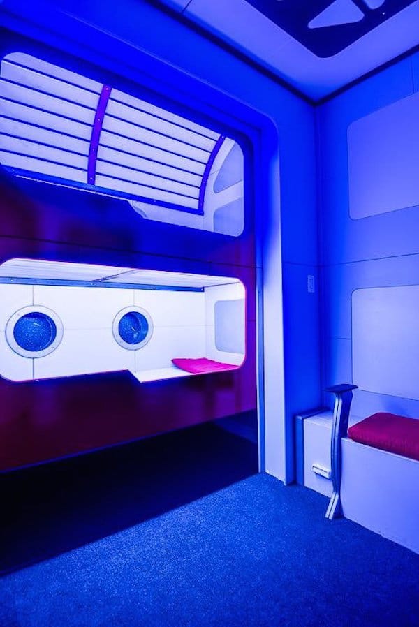blue-lighting-brings-the-sci-fi-experience-home-especially-in-the-pod-style-bunk-beds