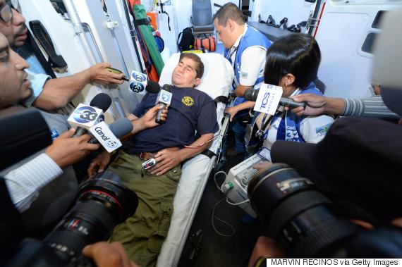 Salvadorean castaway Jose Salvador Alvarenga speaks to journalists in an ambulance on his way to San Rafael hospital in Santa Tecla, El Salvador on February 11, 2014. The Salvadoran castaway who says he spent 13 months adrift in the Pacific arrived home Tuesday to the warm embrace of a family that thought him dead. Alvarenga traveled across the ocean by plane this time, two weeks after the fisherman washed ashore in the Marshall Islands, telling the world he had floated for 12,500 kilometers (8,000 miles) in a small boat. AFP PHOTO / Marvin Recinos (Photo credit should read Marvin RECINOS/AFP/Getty Images)