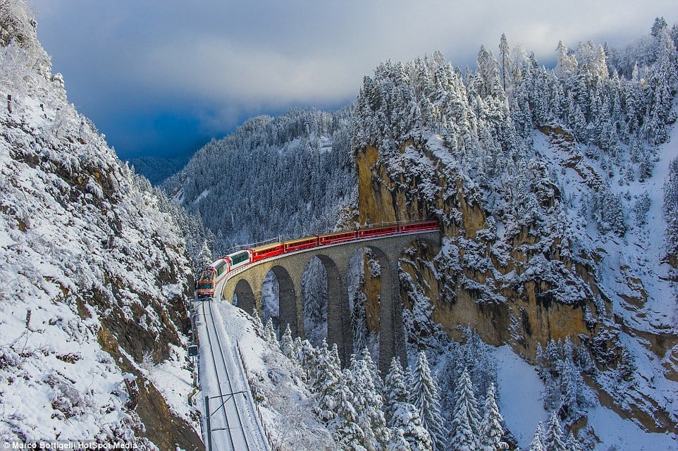 31F2FE9E00000578-0-Rolling_across_a_65_metre_high_viaduct_in_the_Alps_the_red_carri-a-47_1457355342452