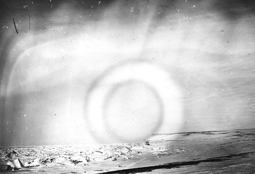 The Aurora Borealis, a luminous phenomenon, otherwise called the 'Northern Lights' is viewed over the Arctic, photographed by members of the British Nares expedition. Their ship can be seen trapped in sea ice in the bay.   (Photo by Hulton Archive/Getty Images)