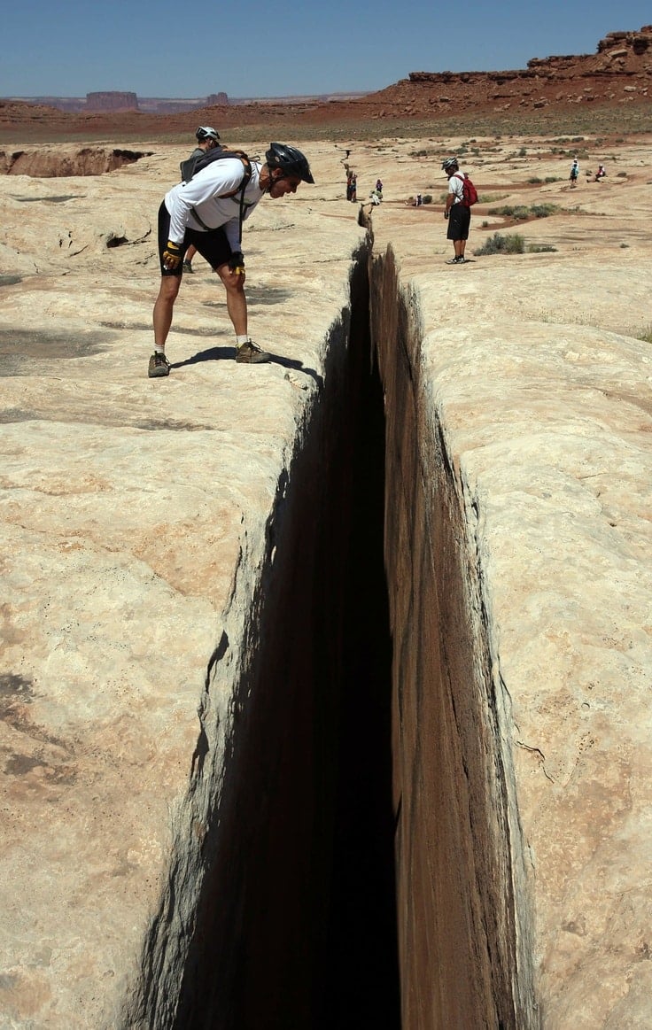 Francisco Kjolseth | The Salt Lake Tribune Andy Walker of Sandy peers down the impressive Black Crack formation found along the White Rim trail in Canyonlands National Park. Walker was part of a Holiday Expeditions guided mountain biking trip in May, 2013