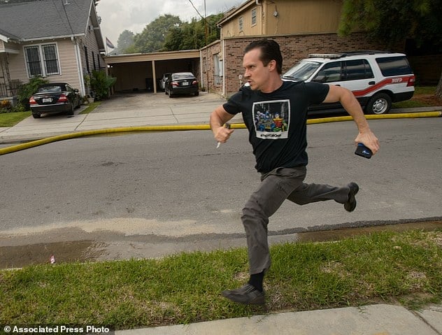 Writer and actor Gideon Hodge runs towards his burning home in New Orleans, La., Thursday, Sept. 15, 2016. Hodge then rushed into the structure – past firefighters yelling at him to stop – to grab his laptop, which he said had two completed novels on it. (Matthew Hinton/The Advocate via AP)