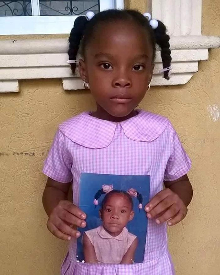 Daughter Holding A Photo Of Her Mother At The Same Age