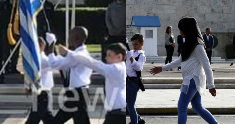 Αφρικανός σημαιοφόρος και παραστάτρια με μαντήλα στην παρέλαση στην Αθήνα