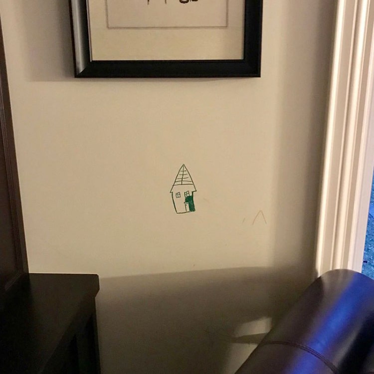 kids drawing on wall framed by parents 3