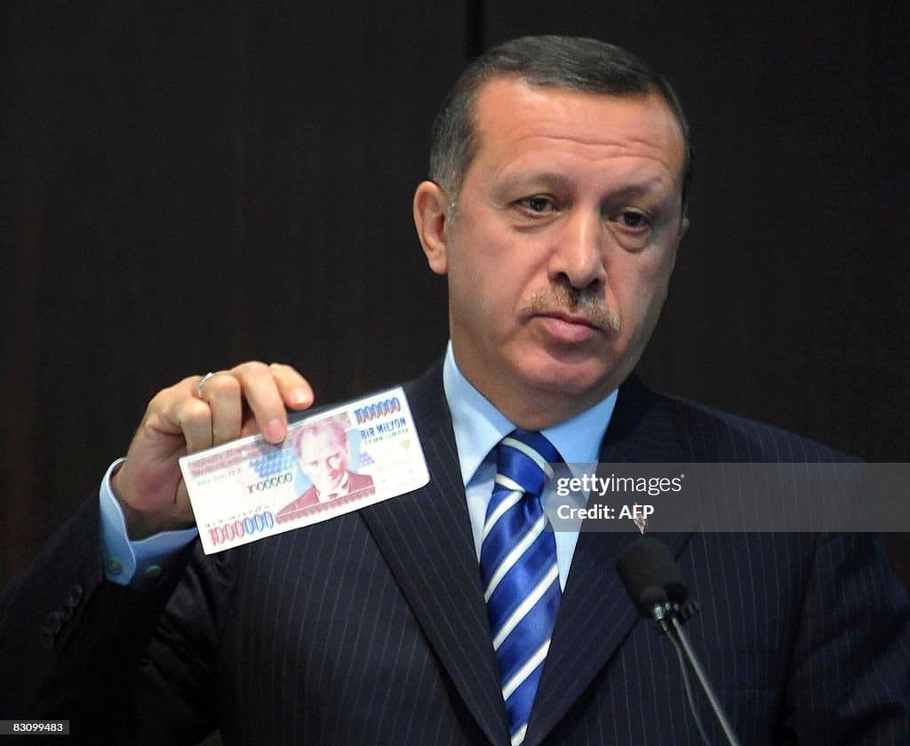 turkish prime minister tayyip erdogan displays an banknote of the old picture id83099483