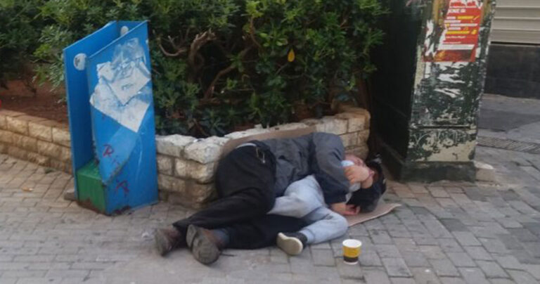 Πατέρας και γιος κοιμούνται αγκαλιά σε πεζόδρομο Μεγάλη Εβδομάδα στον Πειραιά