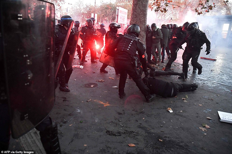 36207938 8996437 french riot police officers detains a person during a protest ag a 35 1606598227849