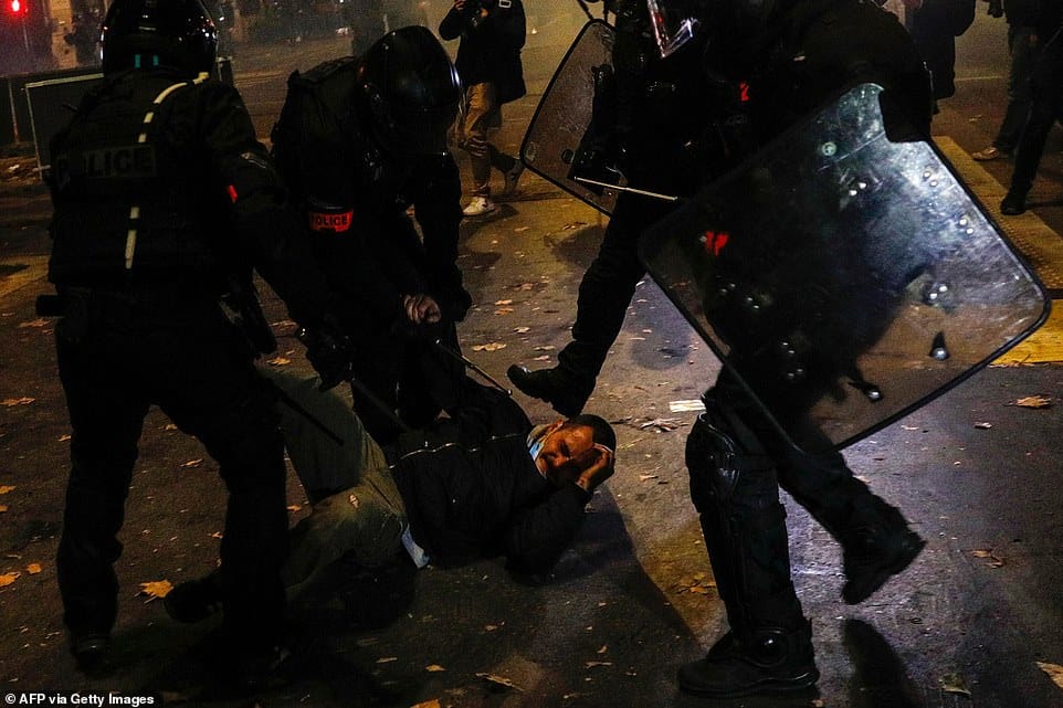 36209694 8996437 police officers in paris arrest and beat a protester on saturday a 33 1606598224719