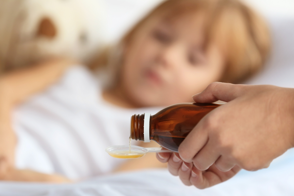 pouring cough syrup for child
