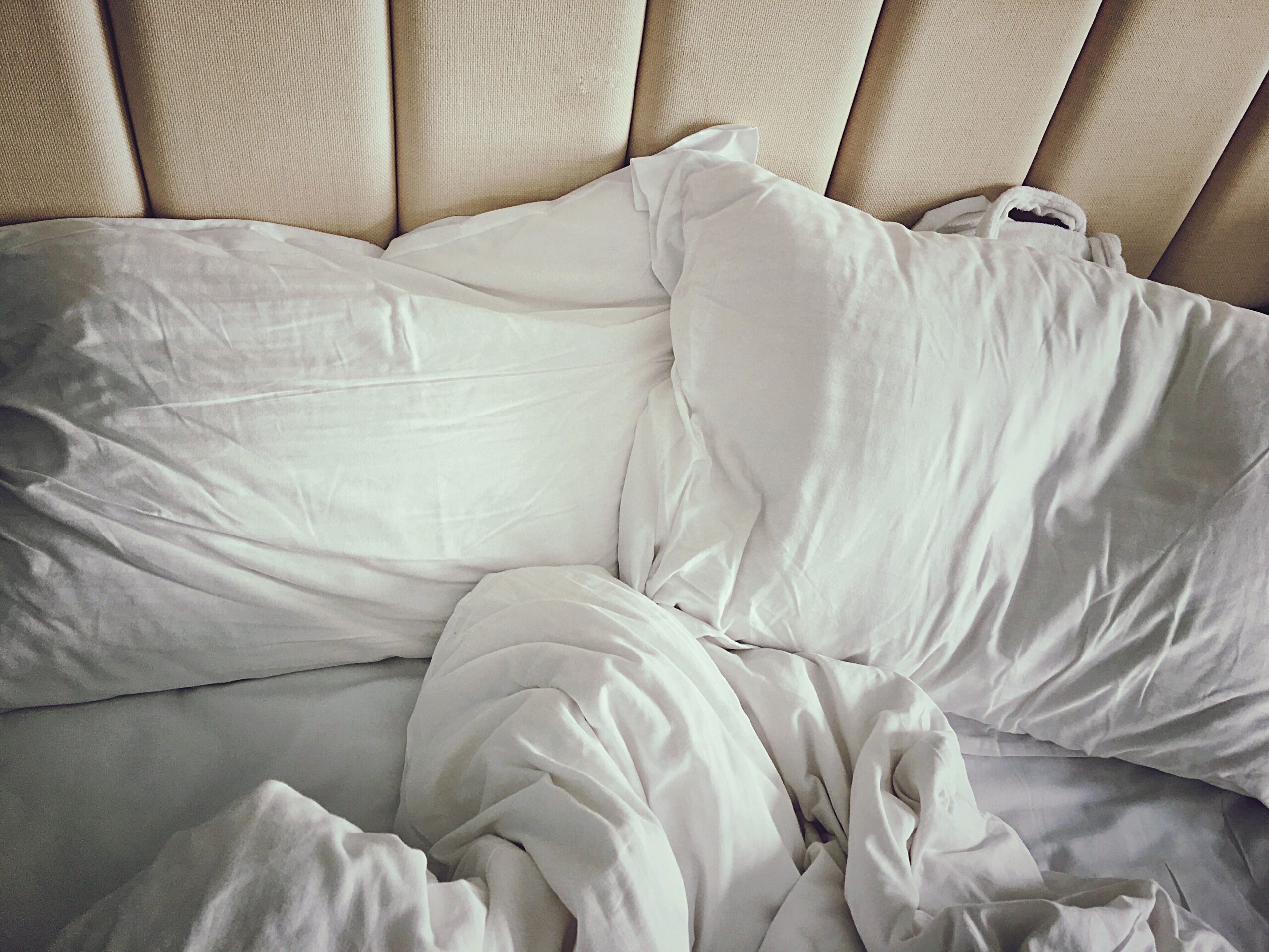 messy bed with white sheets royalty free image 636746579 1548883332 scaled