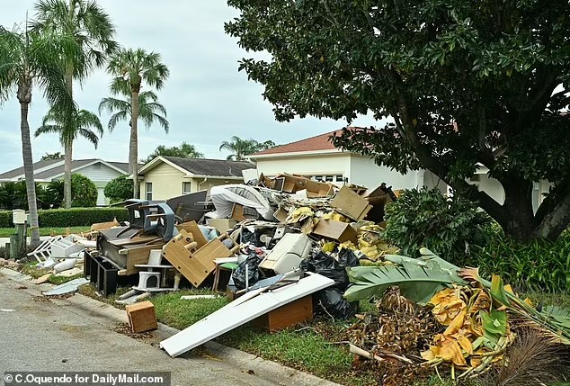 90612741 13938421 damaged homes and debris littered street of tampa florida neighb a 27 1728416868527