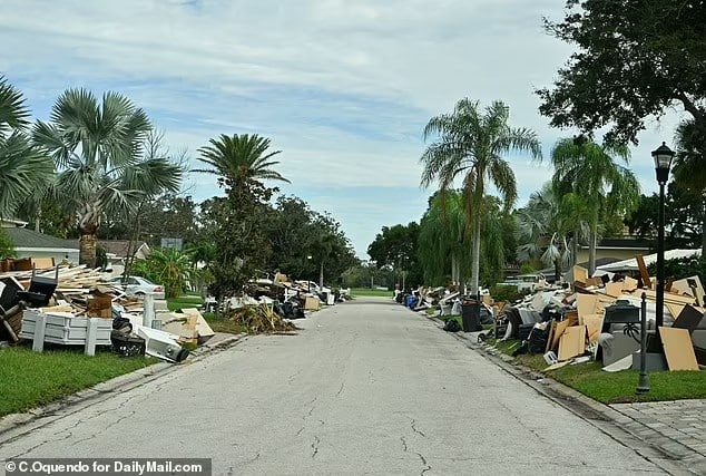 90613715 13938421 damaged homes and debris littered street of tampa florida neighb a 45 1728423451467