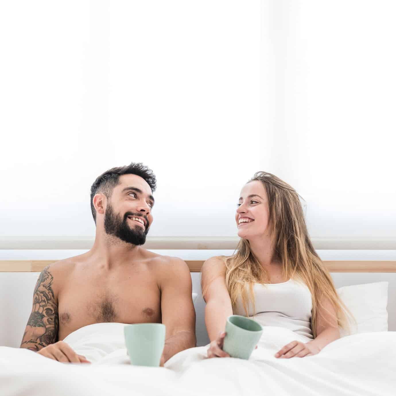 happy couple with cup coffee looking each other 23 2147911995