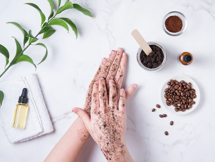 spa concept young woman does hand massage with homemade coffee scrub from recycle capsule with olive oil marble background top view 185452 1188