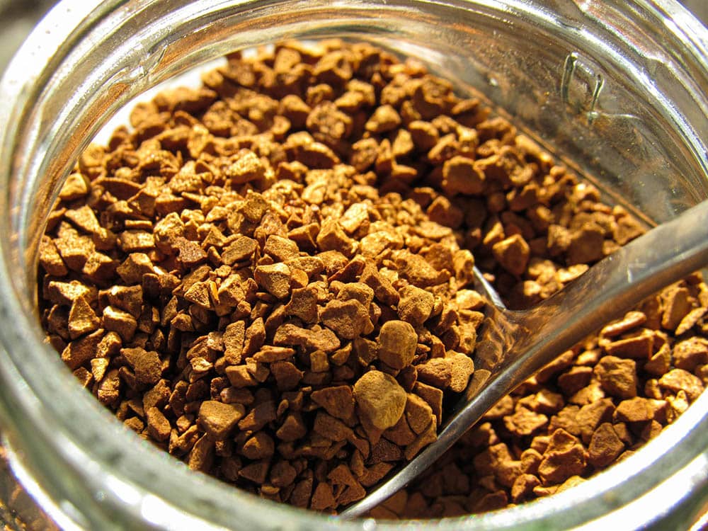 close up scooping instant coffee from jar karyna panchenko unsplash