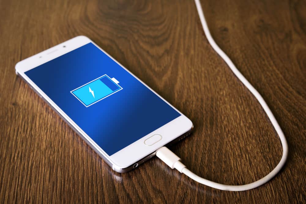 mobile smart phonesphone charging on wooden desk