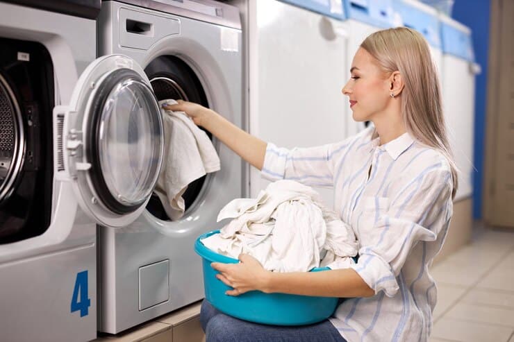 woman doing laundry putting out white garments from washing machine putting it basket basin washing house 183219 5836