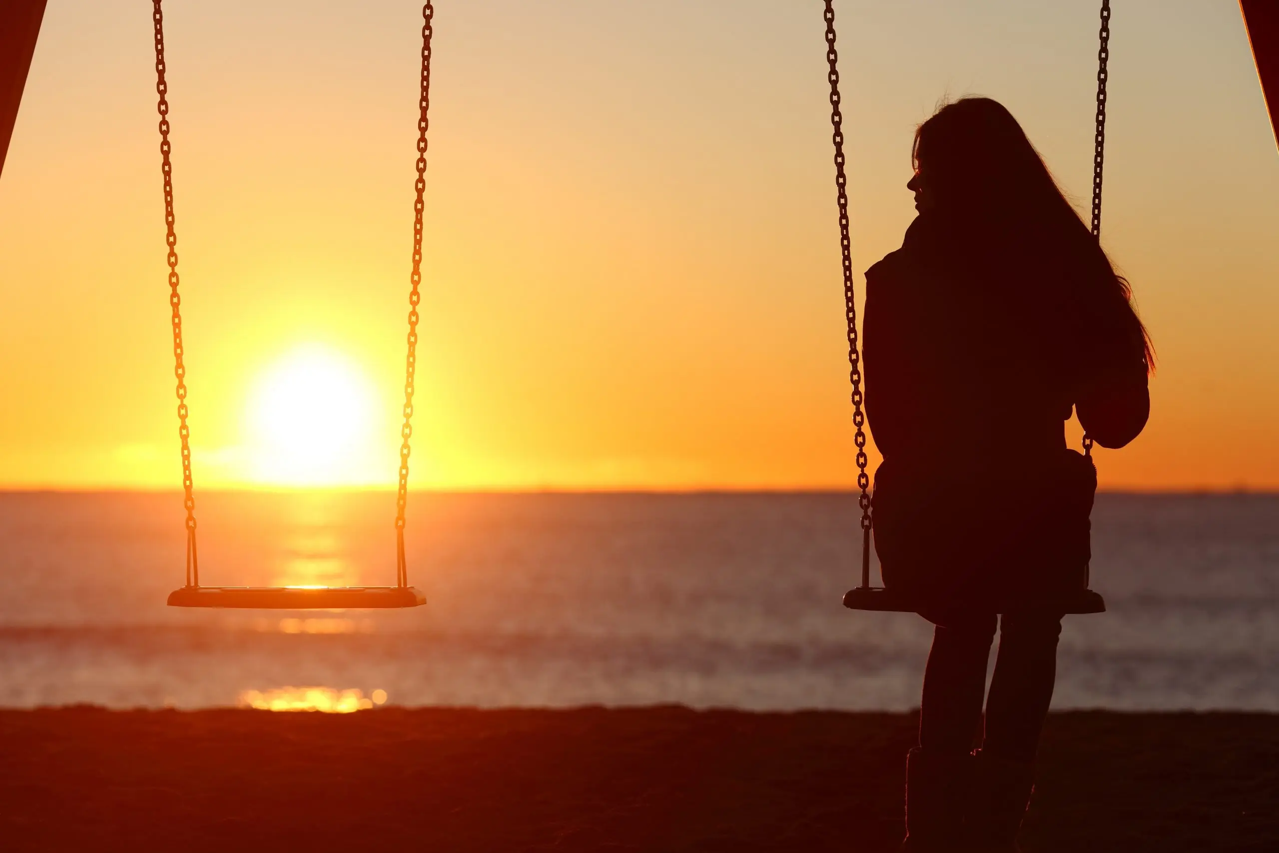 single woman on the beach swinng alone depositphotos 74688765 xl 2015 scaled 1