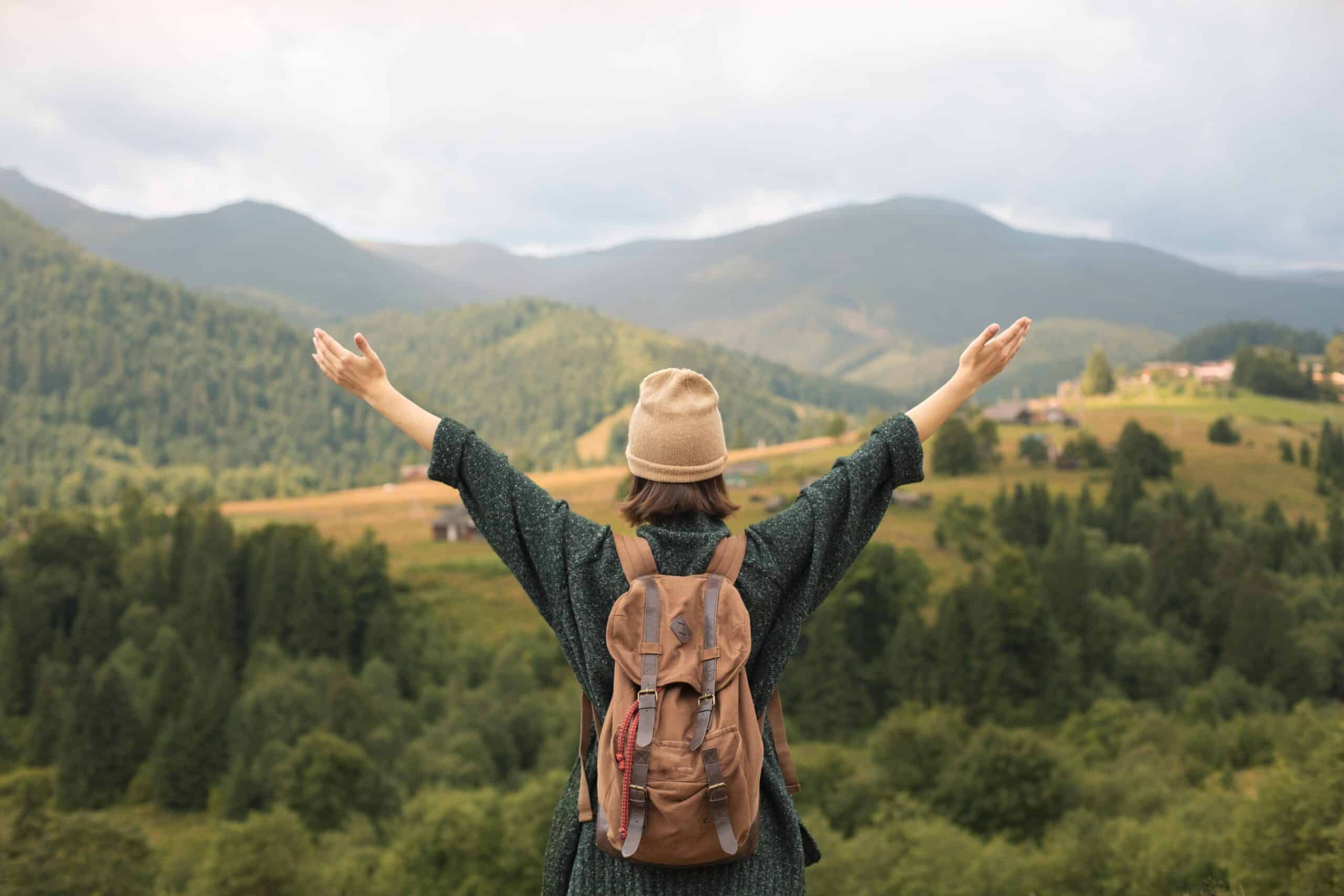 young female traveler enjoying rural surroundings scaled