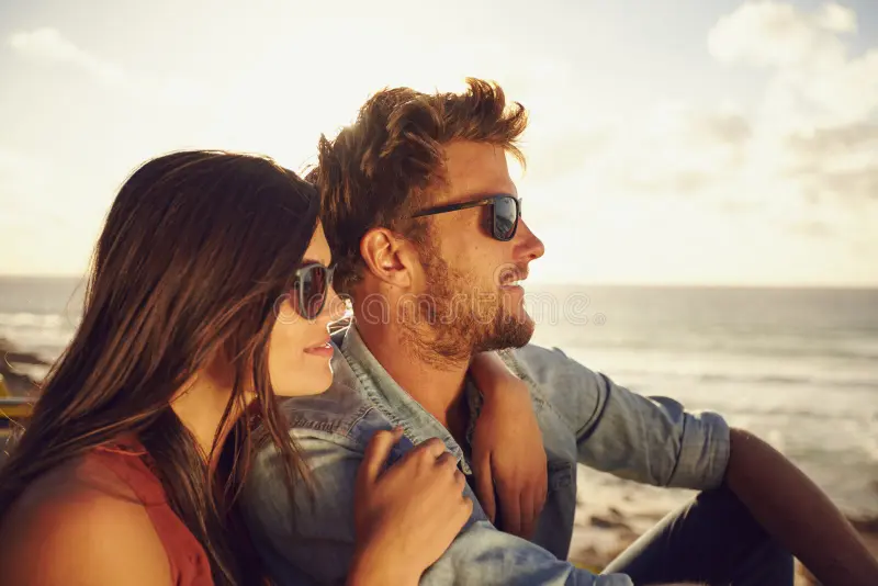 beautiful young couple enjoying view together outdoors summer day caucasian beach both wearing sunglasses 53165169