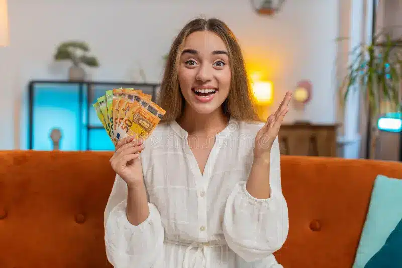 successful rich happy smiling woman holding waving euro bills money fan winning online lottery game successful rich caucasian 393391420