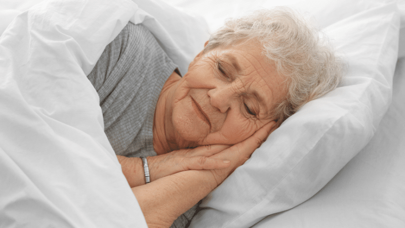 elderly woman sleeping in bed