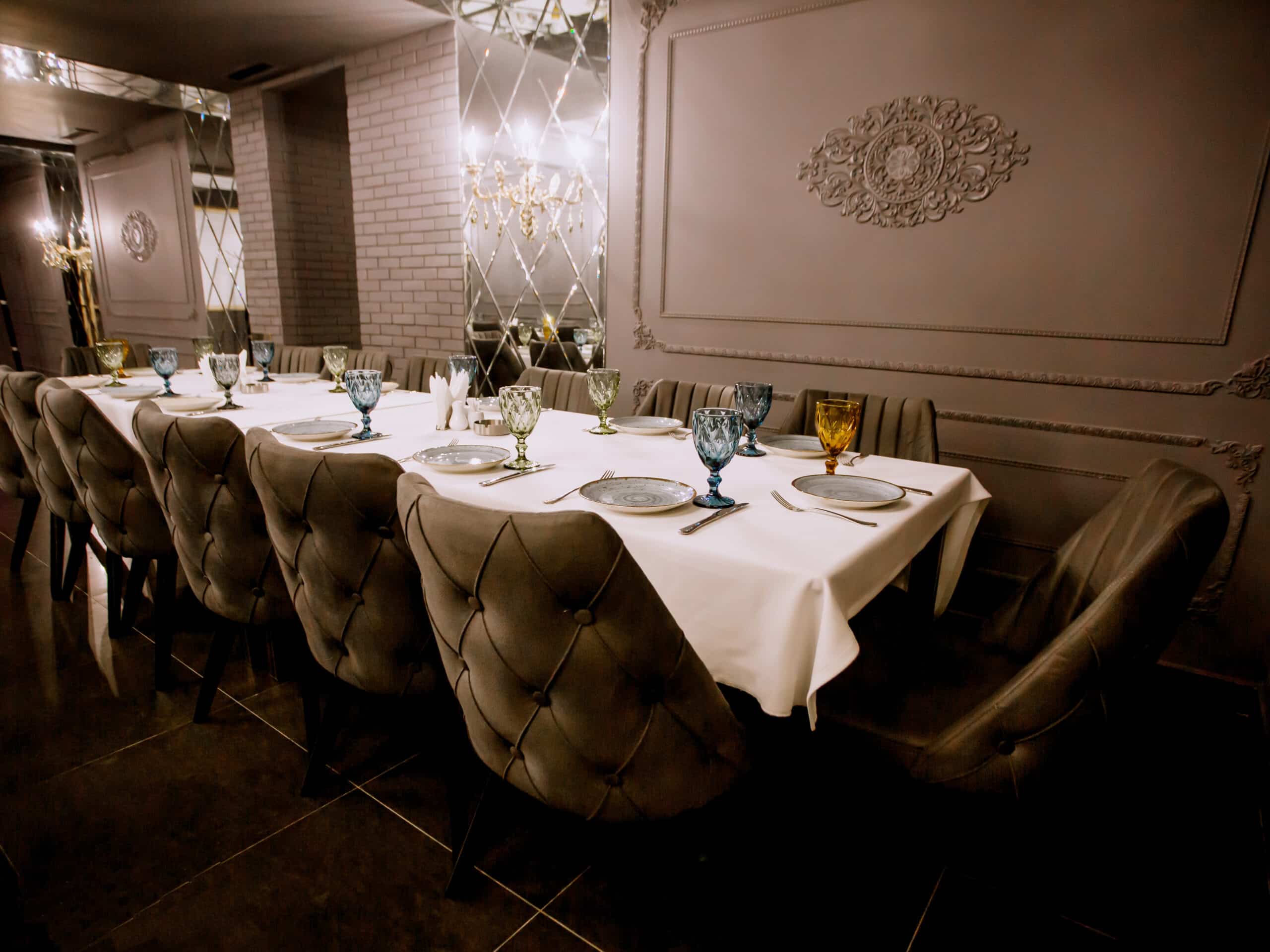 grey painted fancy restaurant with empty dinner table scaled