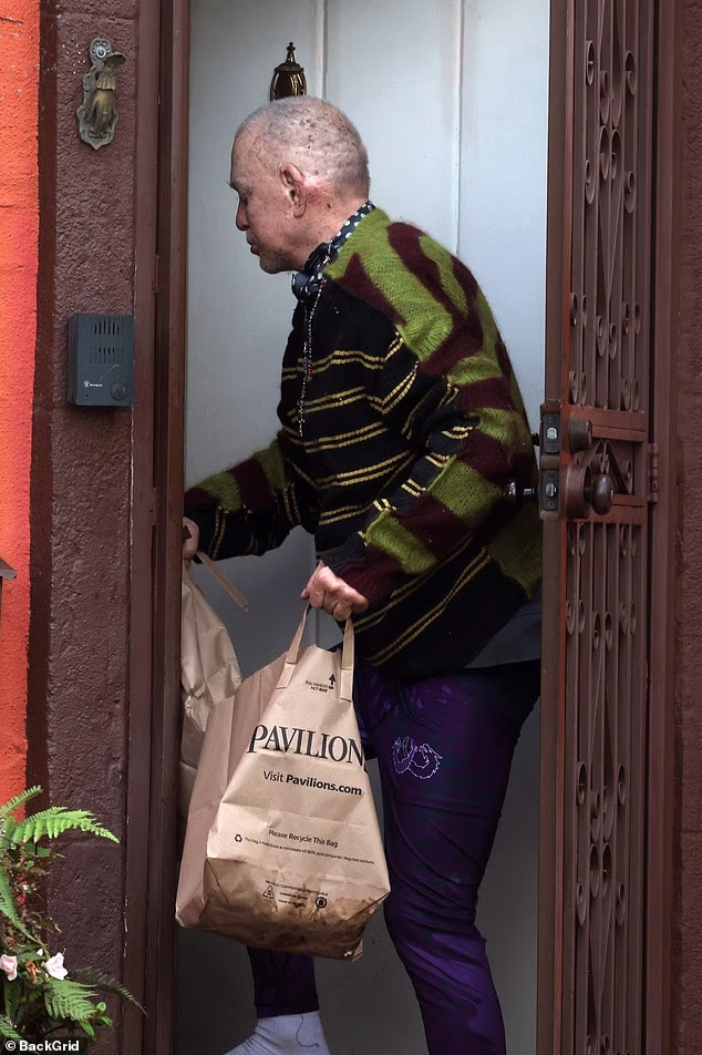 105184059 15429571 wearing a striped sweater rosary and no shoes on a frail rourke a 5 1767394051875