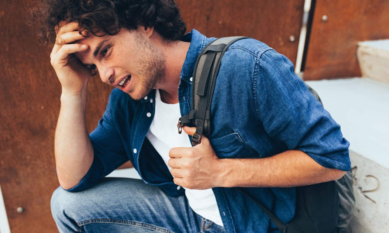 74ef57da bigstock upset young man sitting at con 308145346