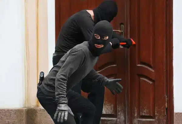 depositphotos 122698402 stock photo armed thieves breaking a door