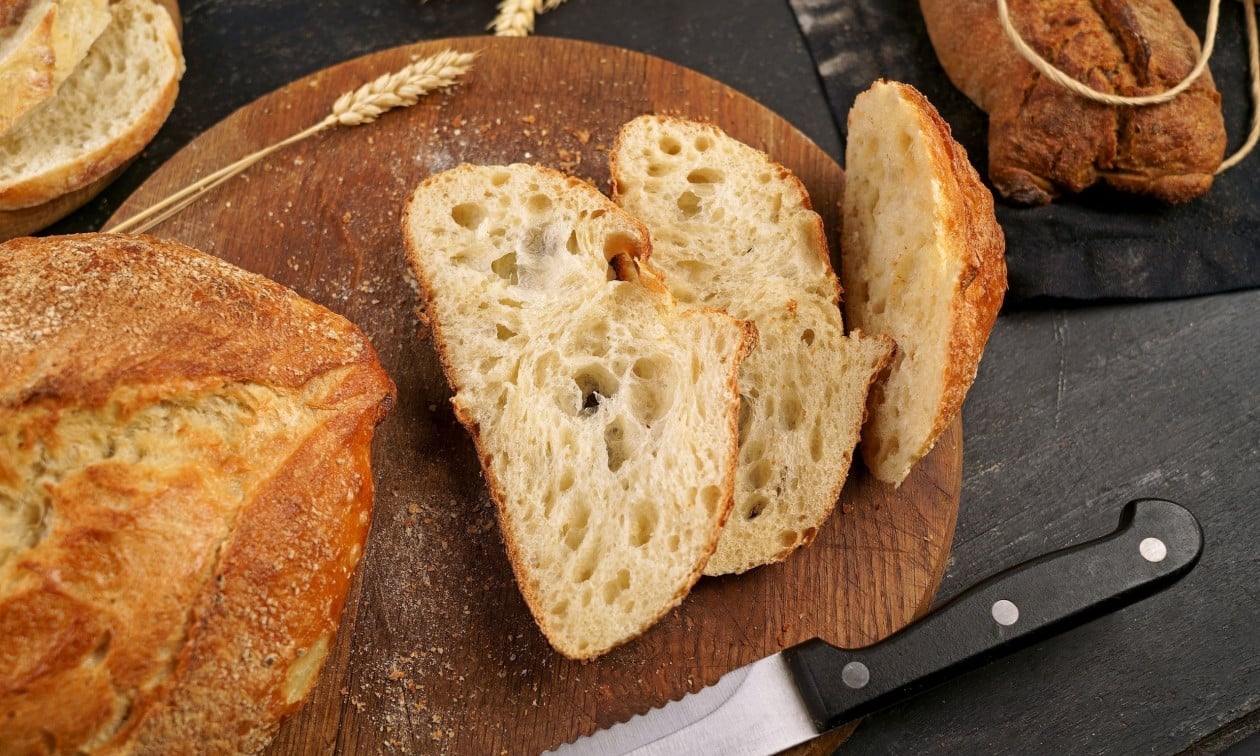 2119ed88 bigstock round loaf of freshly baked so 475175939