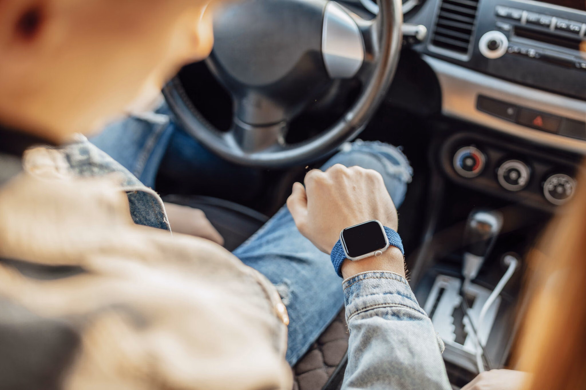 smart watch on the hand of car driver close up transport business trip technology time and people concept 2048x1366 1