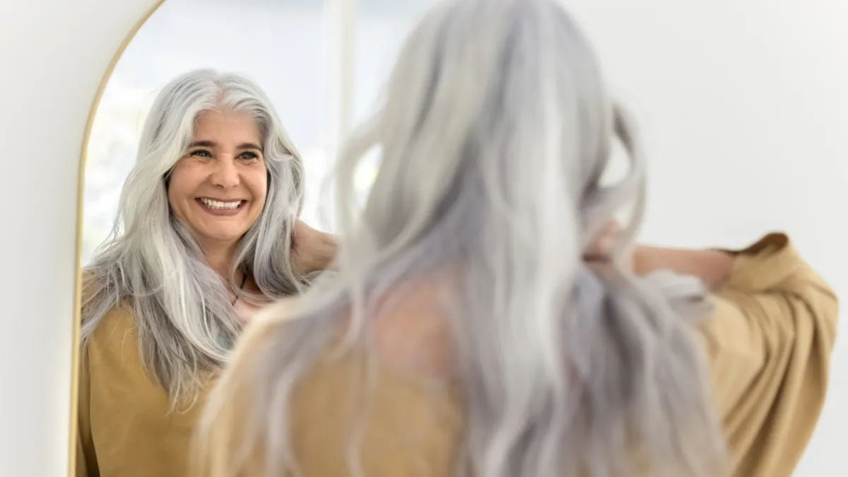 happy positive elderly hispanic woman mirror reflection and back view